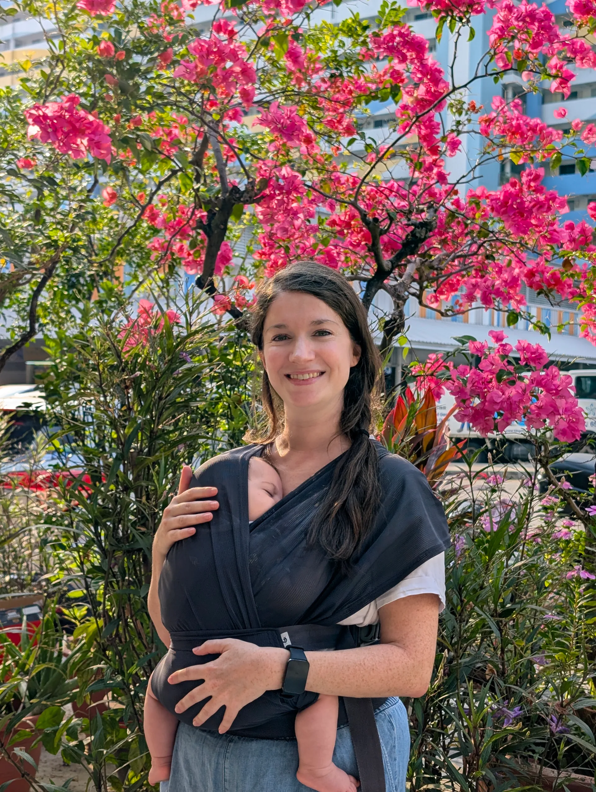 Charlotte, European-trained midwife and birth doula in Singapore, holding a baby